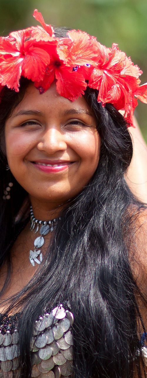 Women in traditional attire with floral crowns