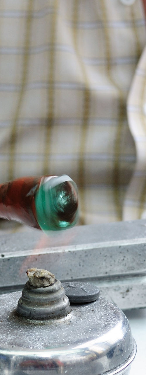 Craftsman shaping green gemstone by hand