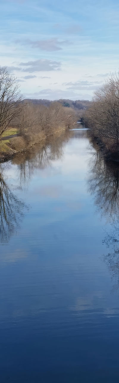 Serene canal with rustic cabin view
