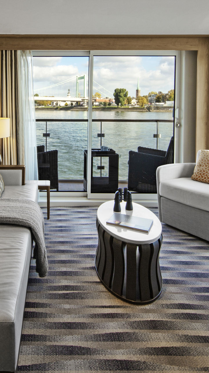 Modern riverfront living room with scenic view