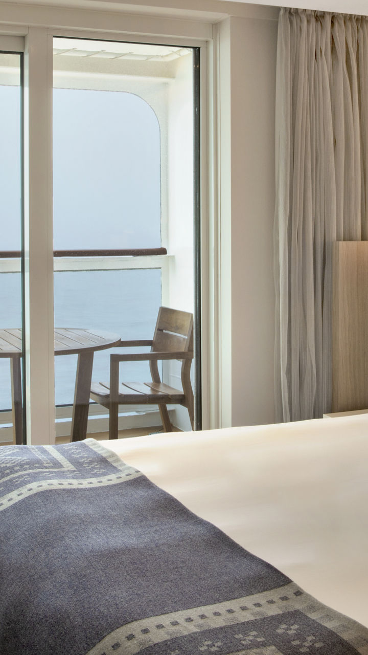 Modern cruise ship cabin with balcony view