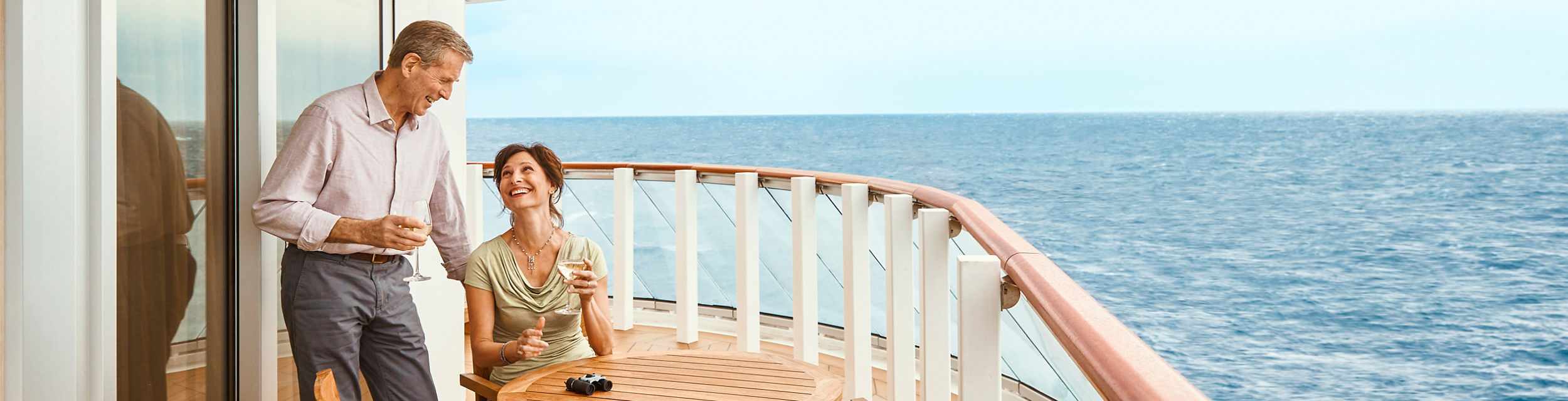 Couple enjoying cruise ship balcony view