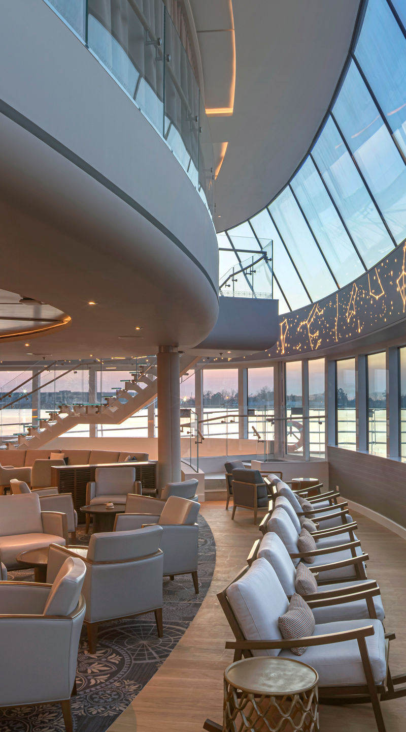 Modern airport lounge with curved glass windows