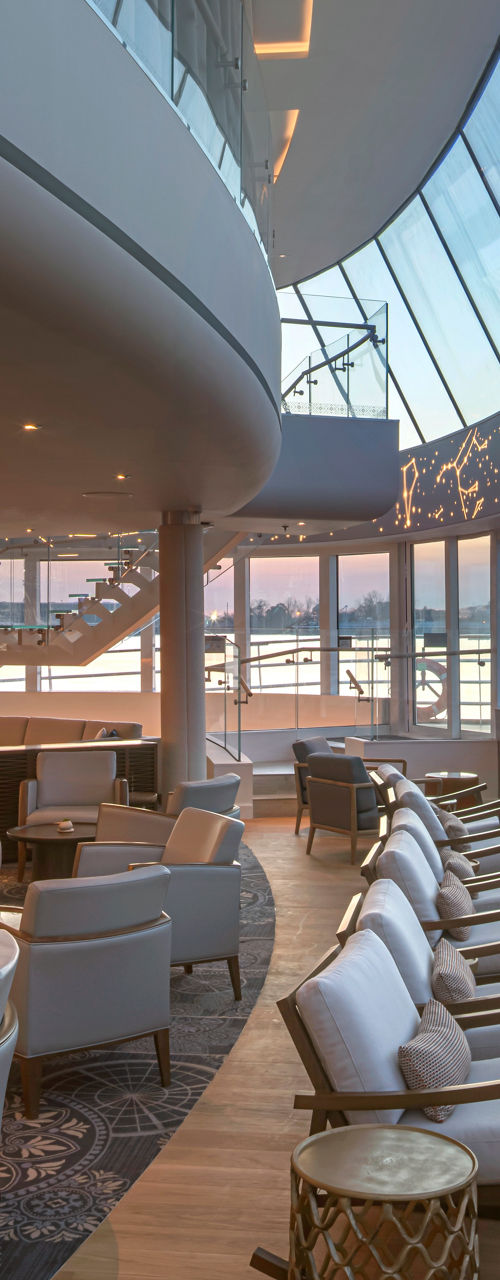 Modern airport lounge with curved glass windows