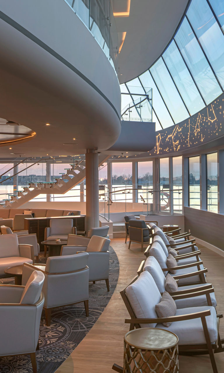 Modern airport lounge with curved glass windows