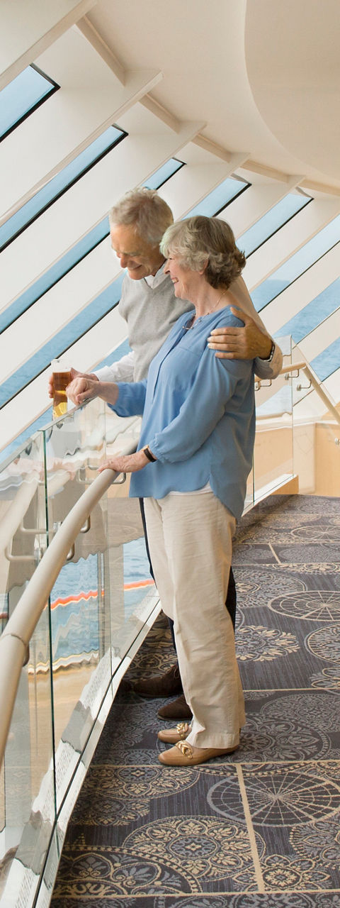 Elderly couple enjoying ocean view indoors