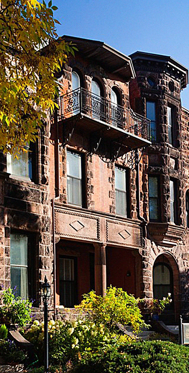 Historic brownstone homes in autumn sunlight