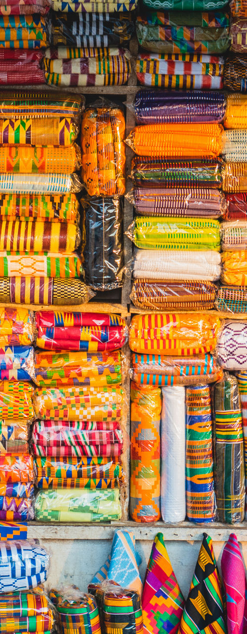 Man browsing colorful African fabric market