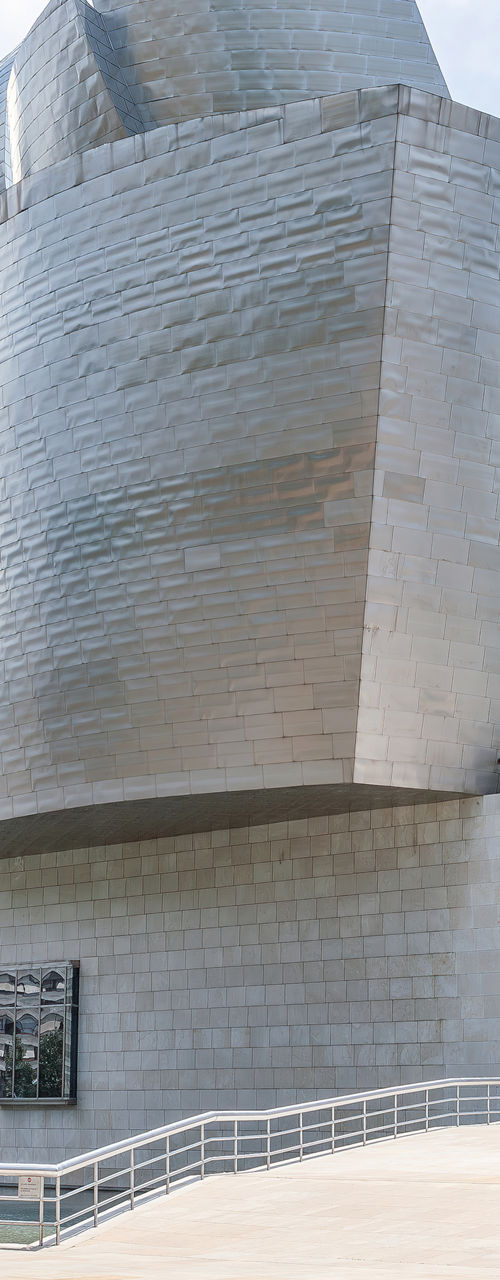 Modern metallic museum exterior with abstract sculpture