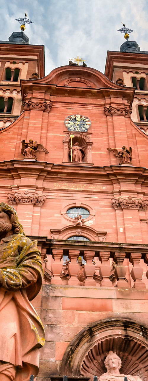 Historic red sandstone church with statues