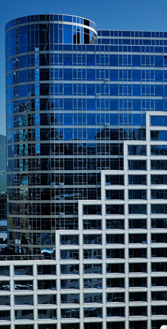 Modern waterfront skyscraper with mountain view