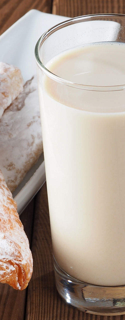 Glass of horchata with pastries and tiger nuts