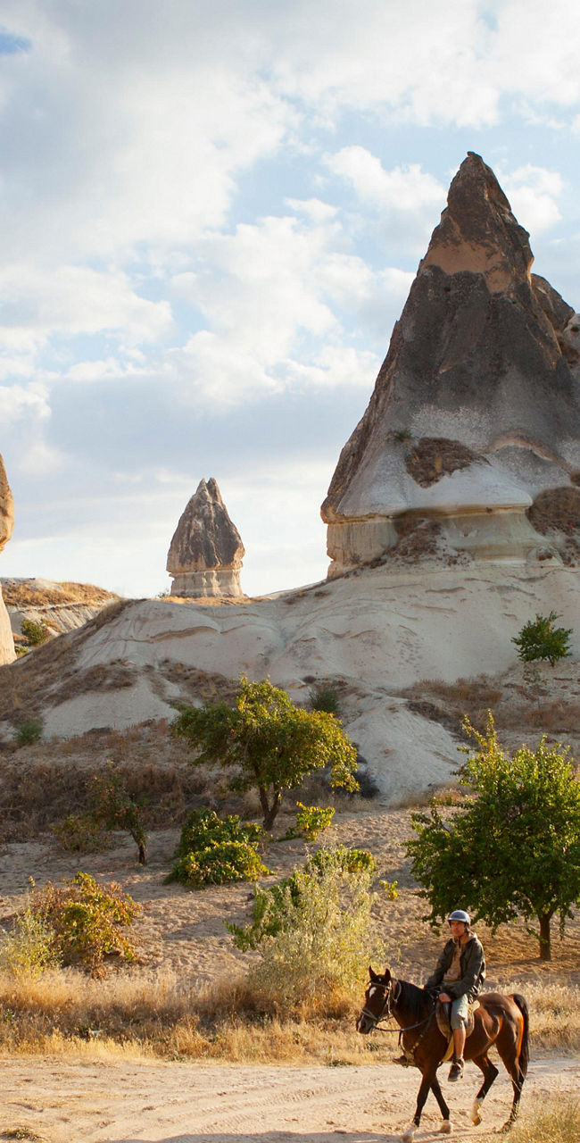 Rider in Cappadocia rock formations landscape