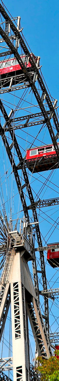 Red Ferris Wheel Against Blue Sky