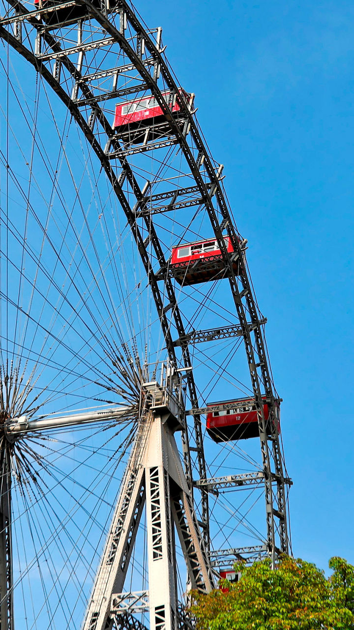 Red Ferris Wheel Against Blue Sky