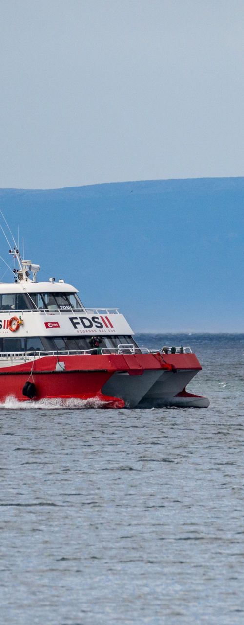 Red and White Passenger Ferry on Open Water