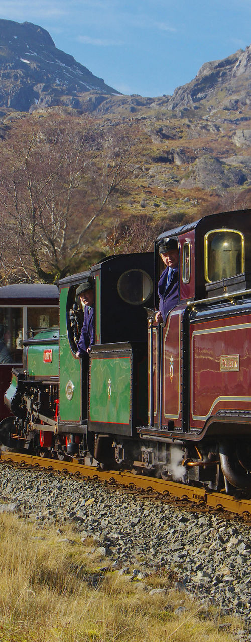 Vintage steam train in scenic mountain landscape