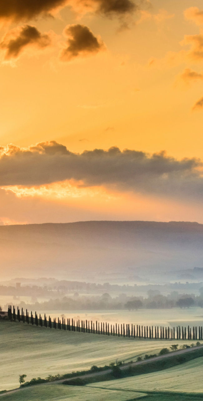 Sunrise over rolling Tuscan countryside