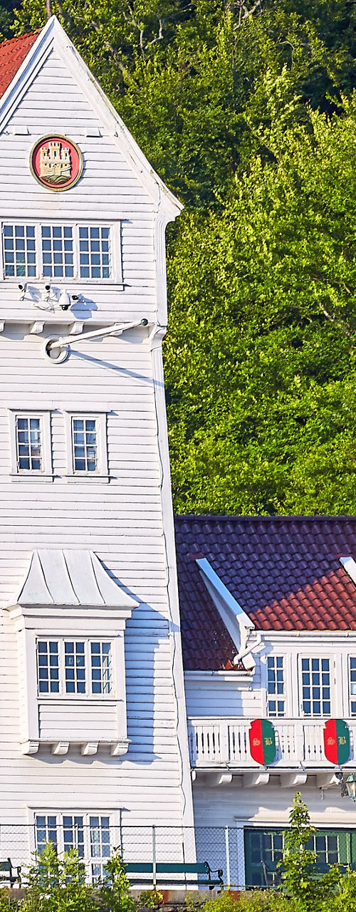 White coastal house with red roof