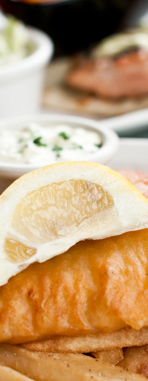 Crispy fish and chips with lemon garnish