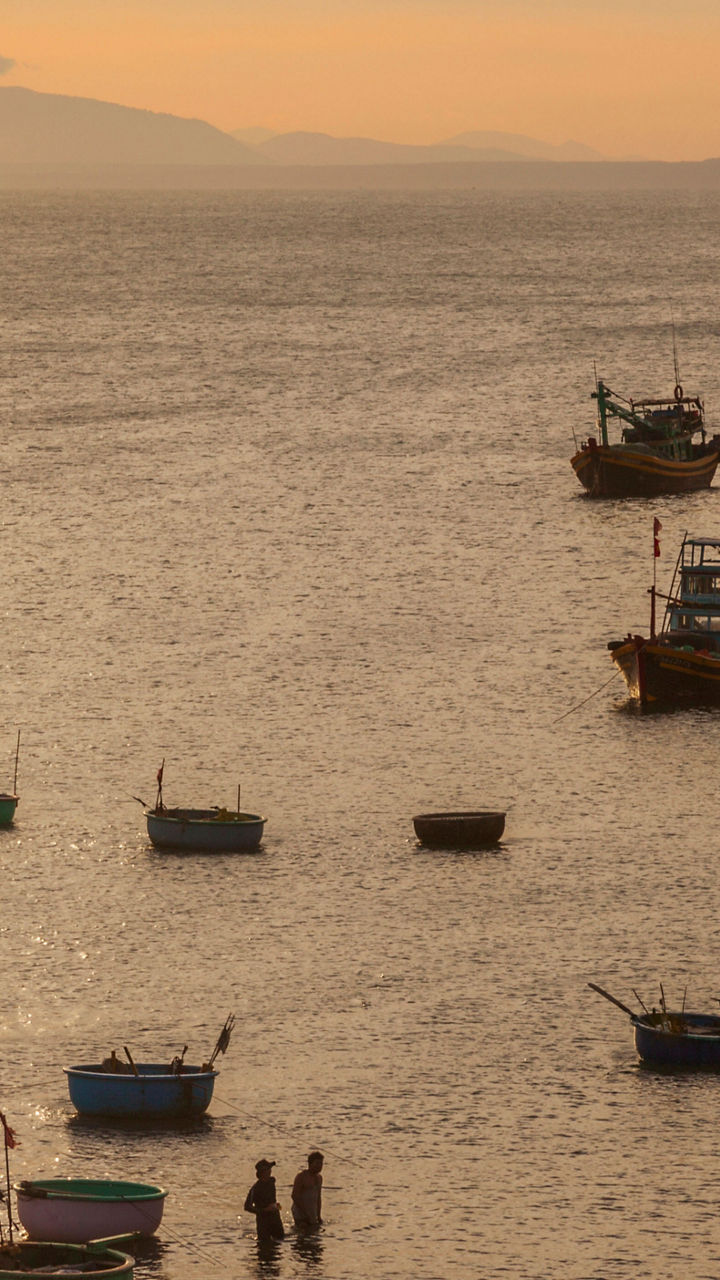 Fishing boats at sunset on calm waters