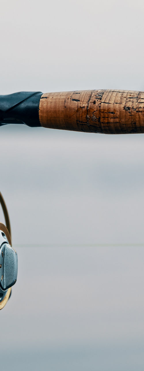 Close-up of hands holding fishing rod
