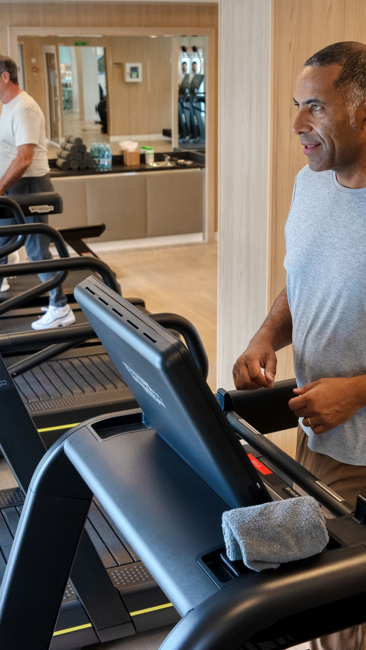 People exercising on treadmills in modern gym