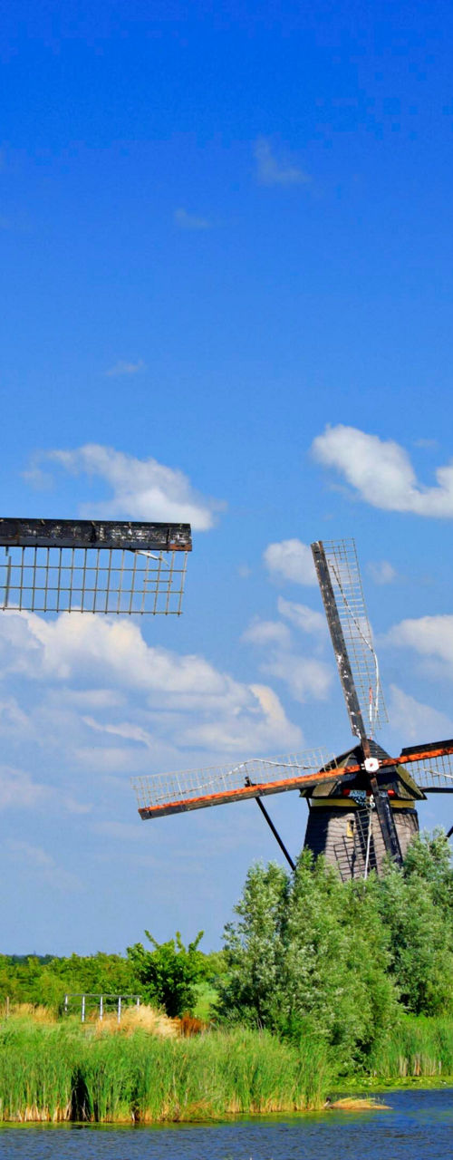 Historic windmills under clear blue sky