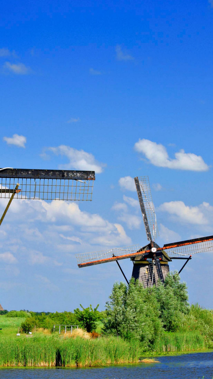 Historic windmills under clear blue sky