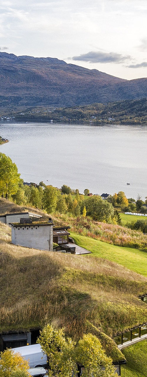 Scenic eco-friendly building by mountain lake