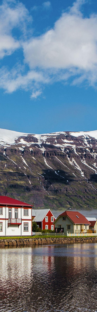 Scenic village with snow-capped mountains