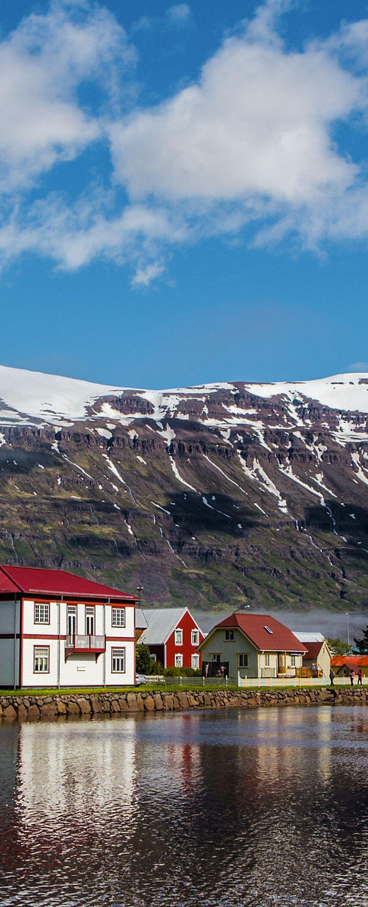 Scenic village with snow-capped mountains