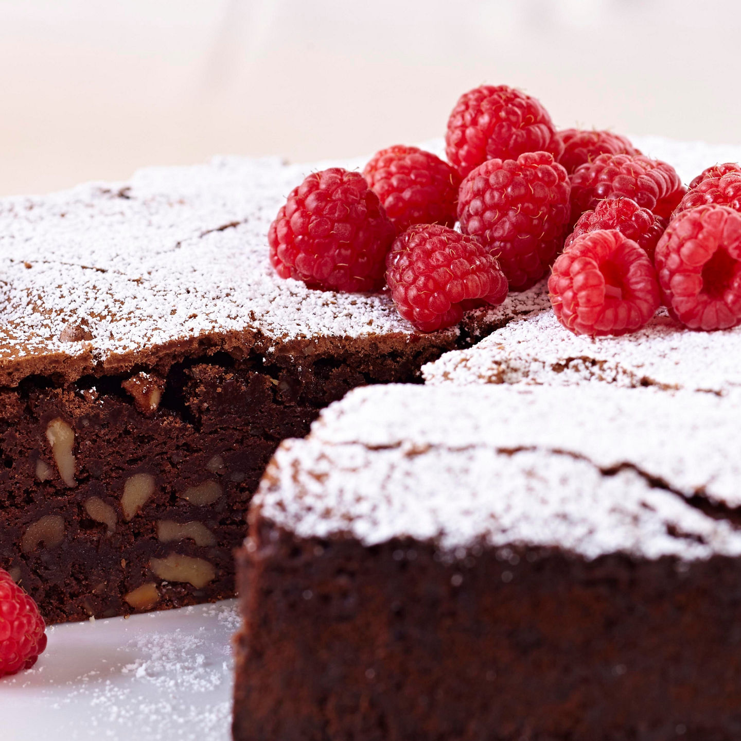 Chocolate cake with raspberries and powdered sugar