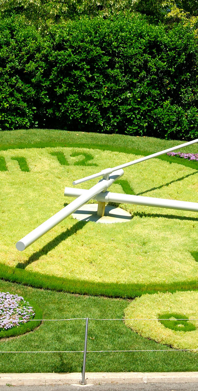 Floral clock in lush garden setting