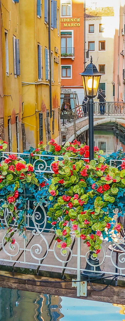 Colorful flower bridge in Venice canal