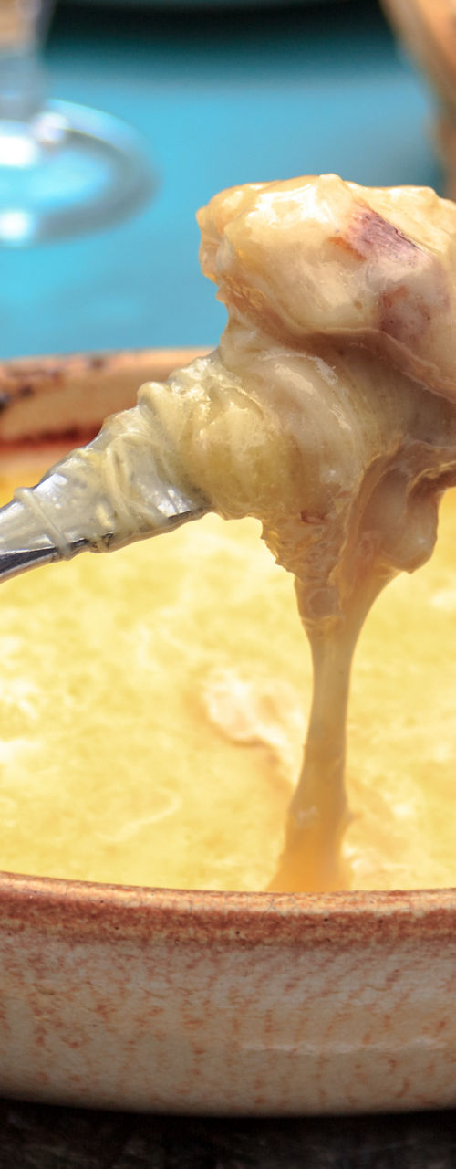 Cheese fondue served in rustic setting
