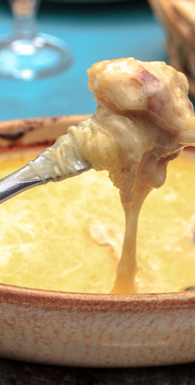 Cheese fondue served in rustic setting