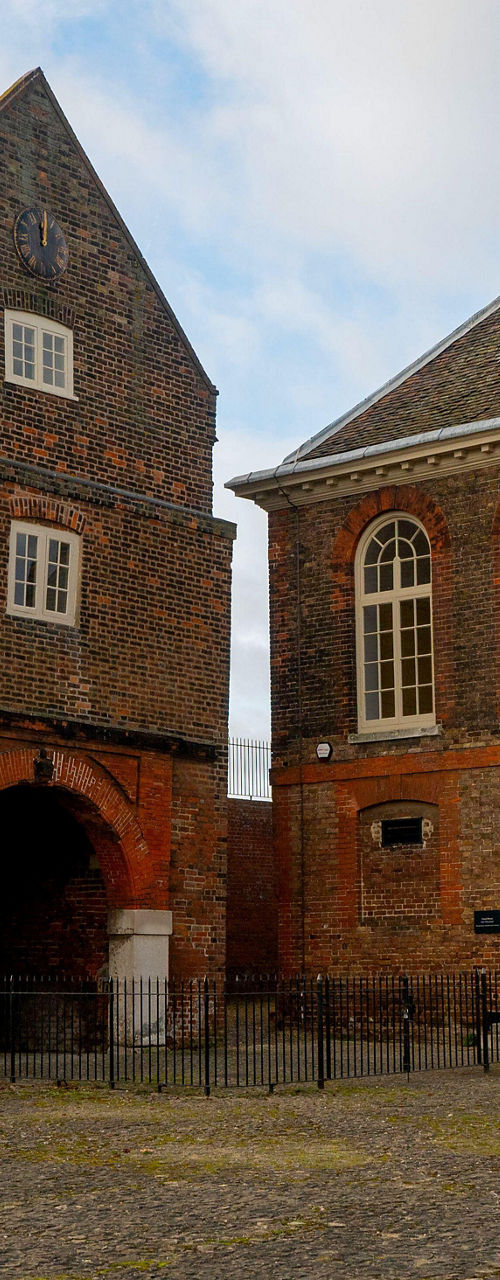 Historic brick buildings with cannons outside