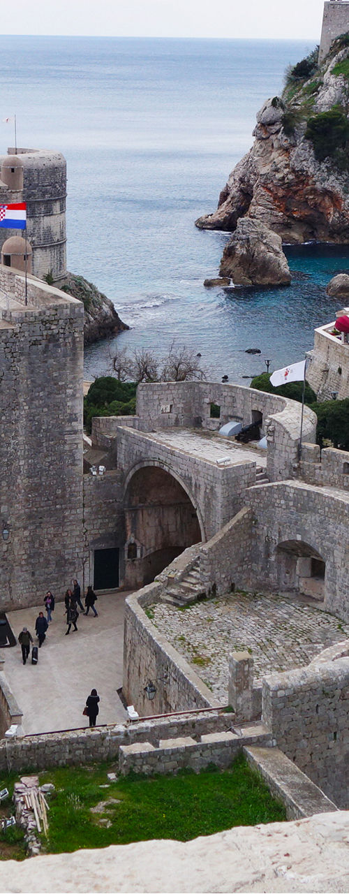 Historic coastal fortress with red rooftops