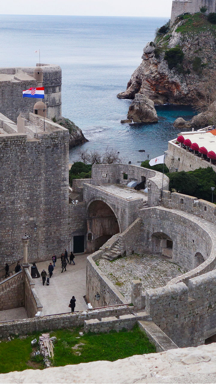 Historic coastal fortress with red rooftops