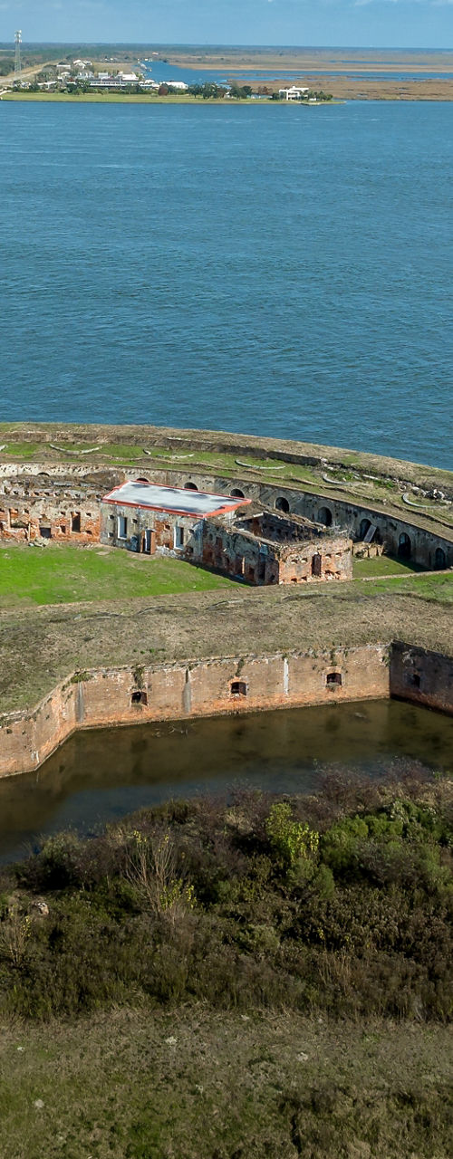 Aerial view of historic coastal fort and bridge