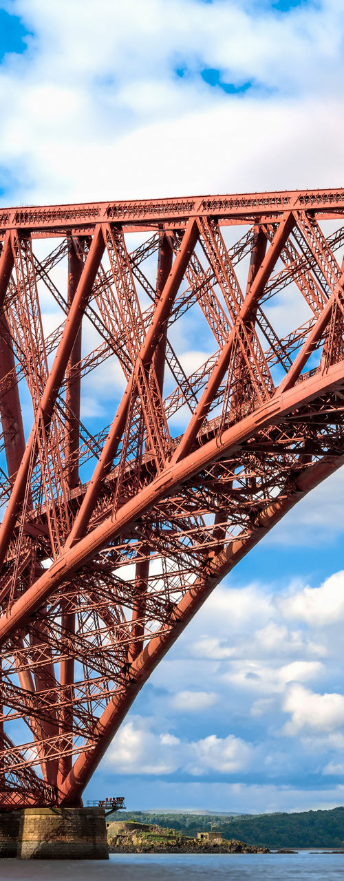 Iconic red steel bridge over calm waters