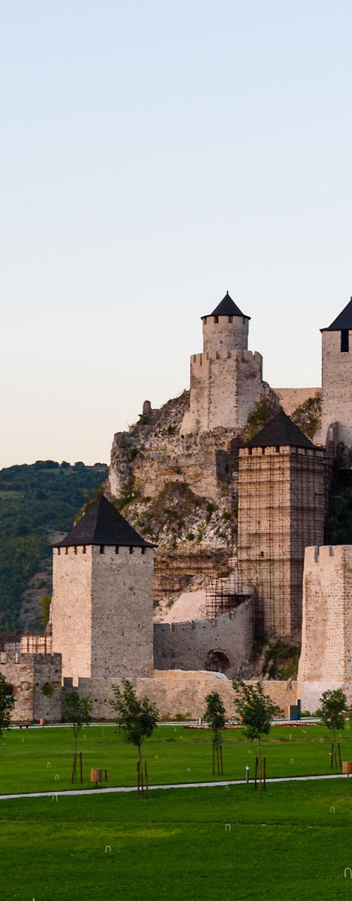 Historic fortress by riverside at sunset
