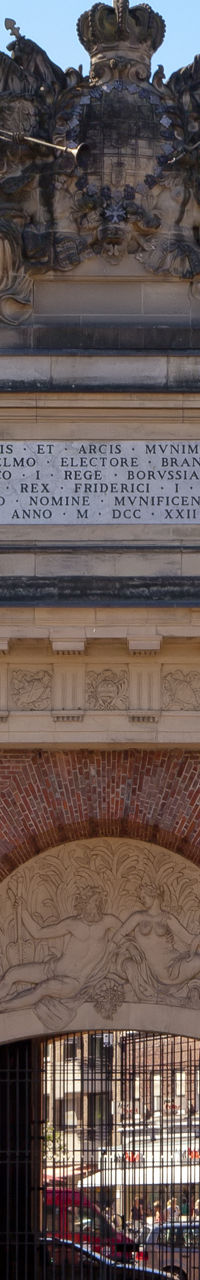 Historic brick archway with flag and statues