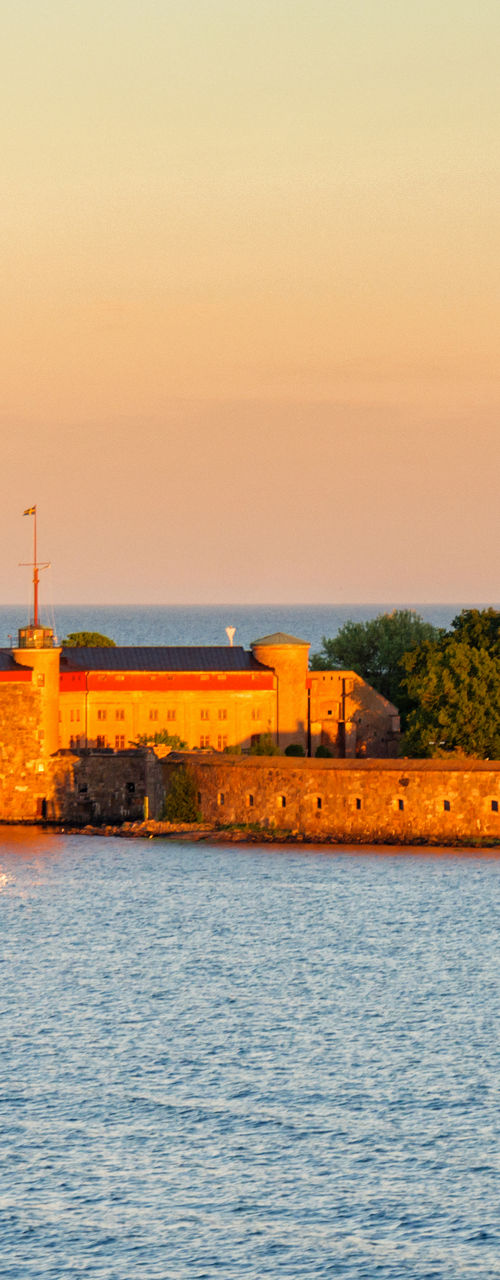Historic coastal fortress at sunset