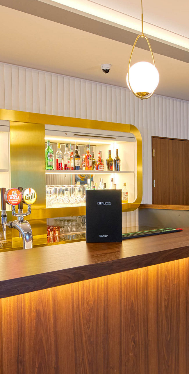 Modern bar interior with wooden counter