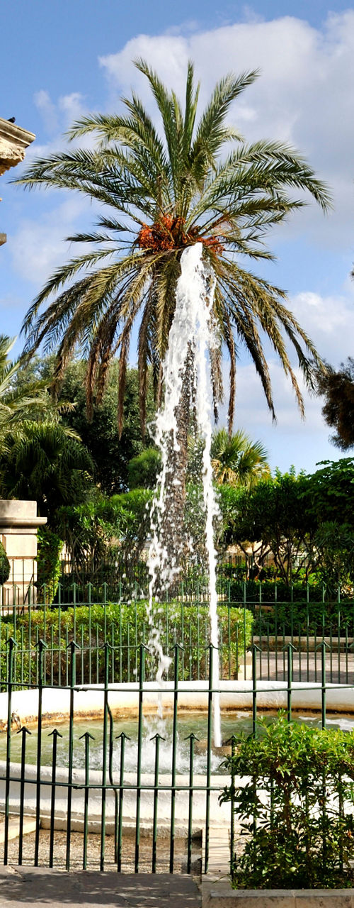 Neoclassical Monument with Fountain in Lush Garden Setting