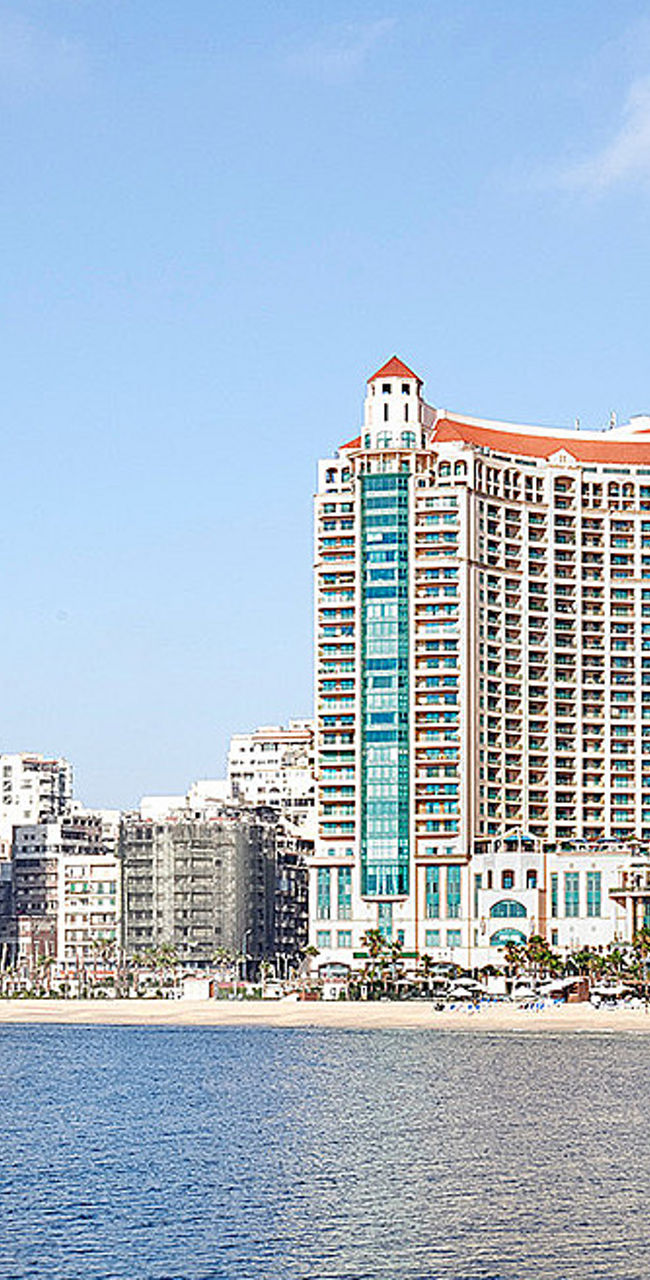 Beachfront luxury hotel with city skyline
