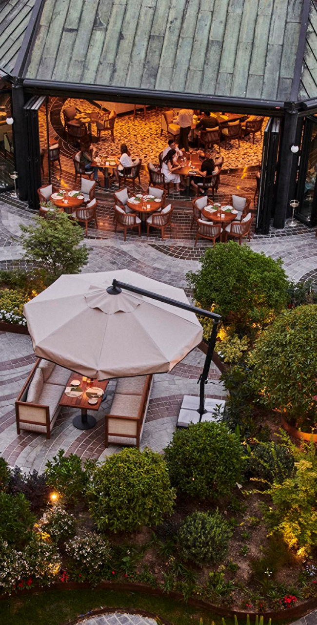 Elegant outdoor restaurant with lush garden