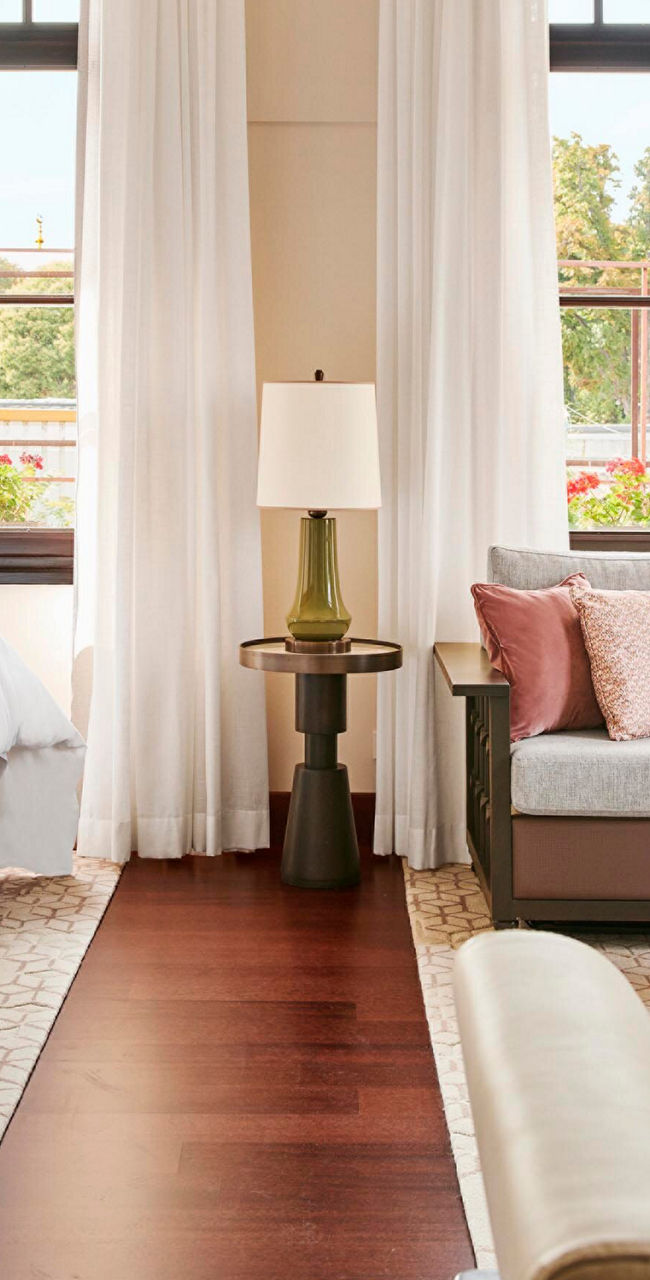 Elegant hotel room with twin beds and seating area